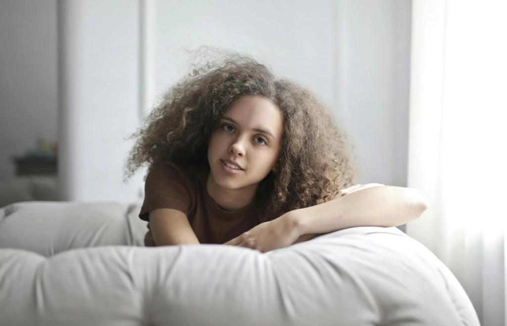 A person relaxing on a couch with a serene expression