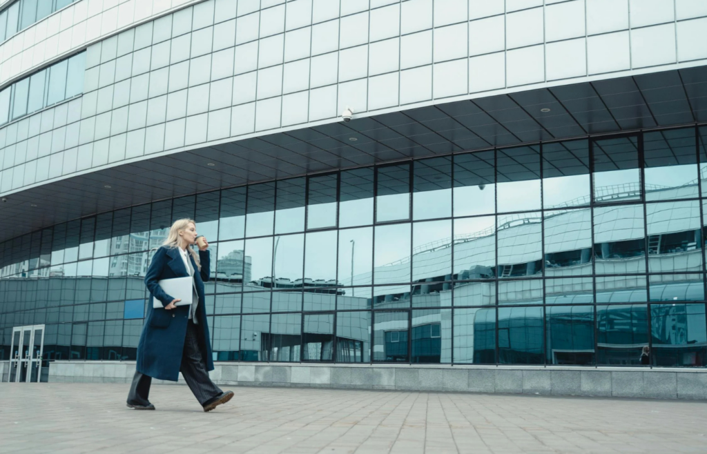 A professional confidently walking into a new office