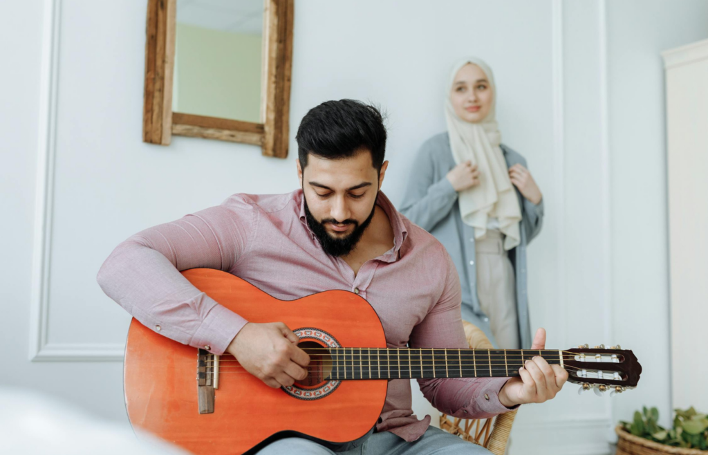 A person enjoying a hobby, like painting or playing guitar