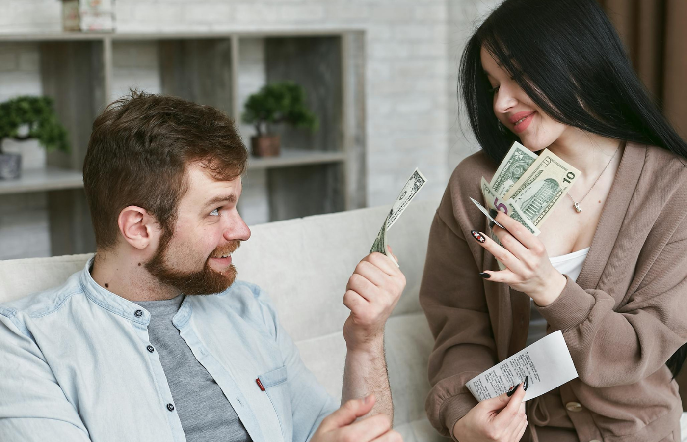 A couple smiling and reviewing finances together