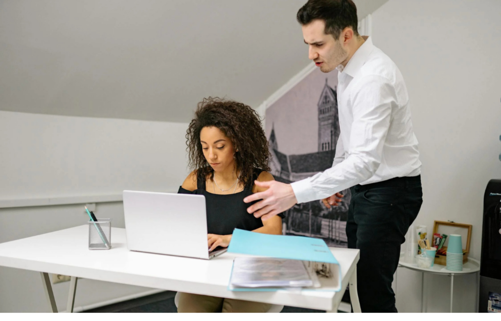 A worker burdened with tasks while others relax