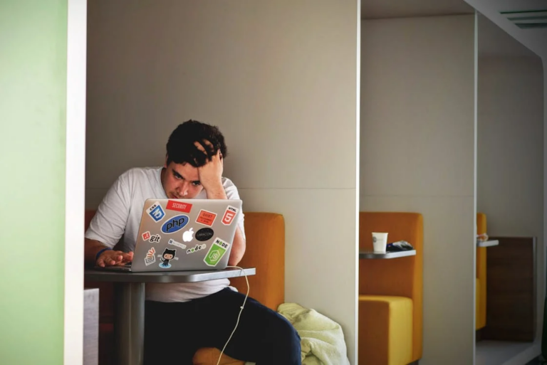 Man Sitting in His Office in Front of a Laptop