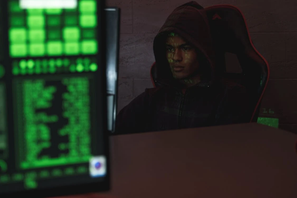 Man in hoodie sitting on a chair