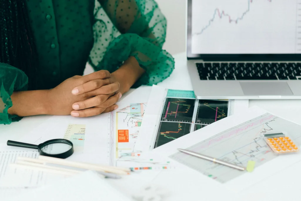 A person reviewing stock charts with a 'Buy' indicator