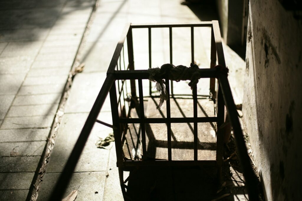 An old metal fire escape on a sidewalk.