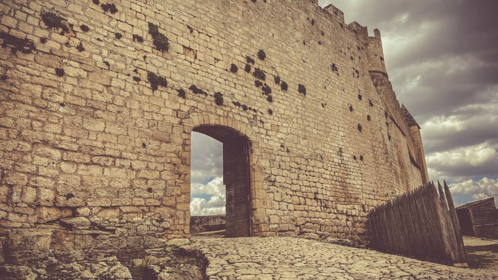 an old brick building with a stone walkway leading to it