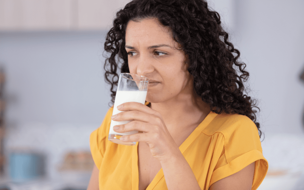 woman sniffing milk