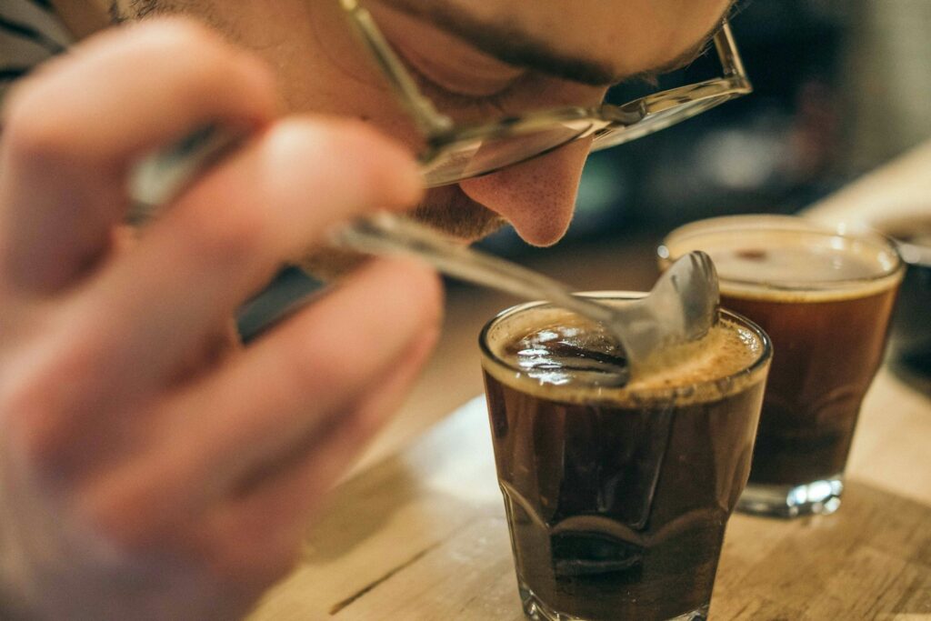 man smelling coffee drink