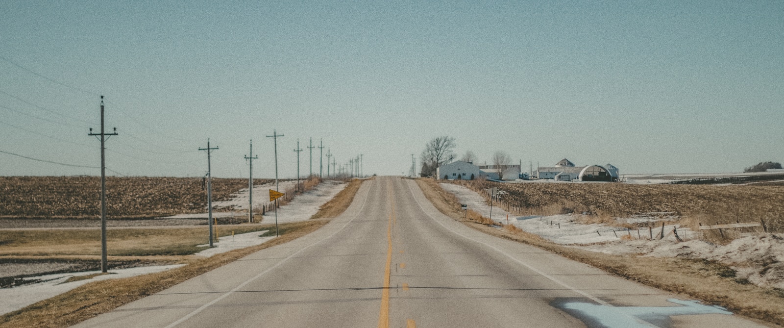 gray concrete road under blue sky during daytime