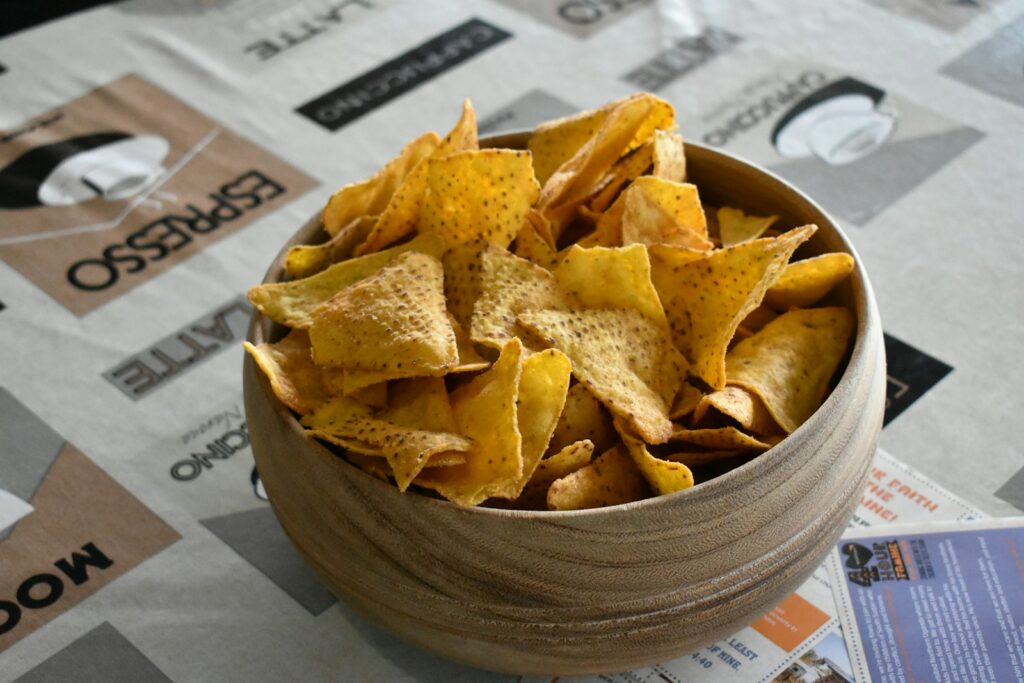 Bowl of crunchy tortilla chips on a patterned tablecloth