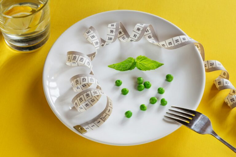 A white plate topped with peas and measuring tape