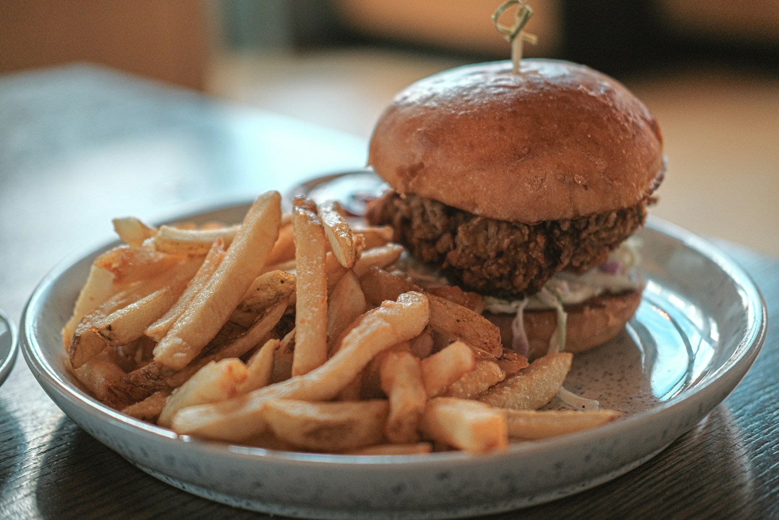 A crispy chicken burger with french fries