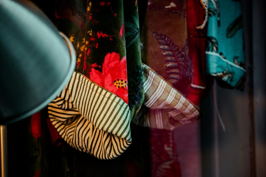 Colorful patterned fabrics hanging in a row.