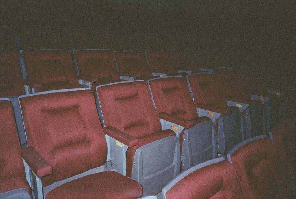 A row of red and gray seats in a stadium