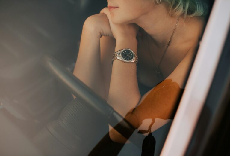 a woman sitting in a car looking out the window