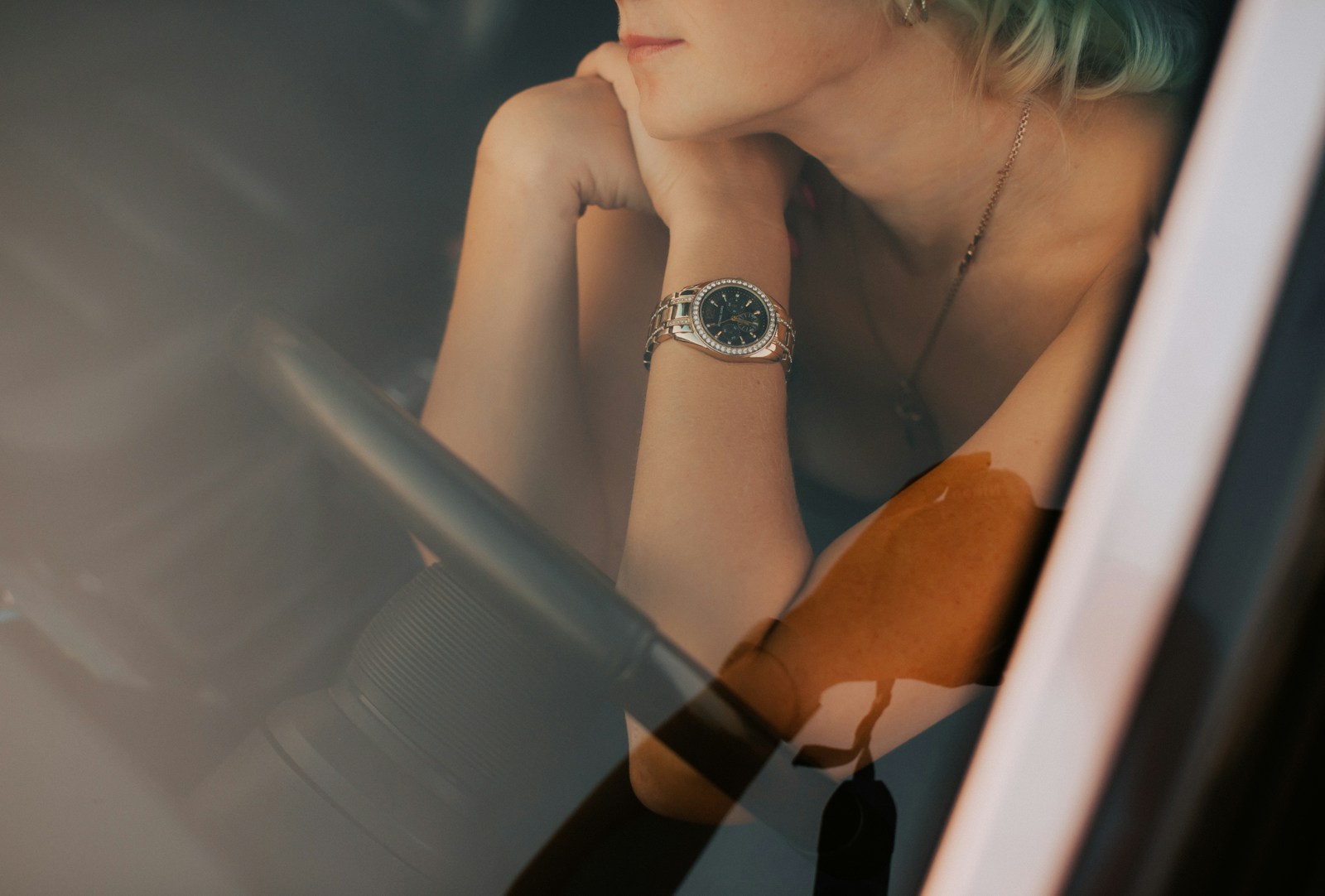 a woman sitting in a car looking out the window