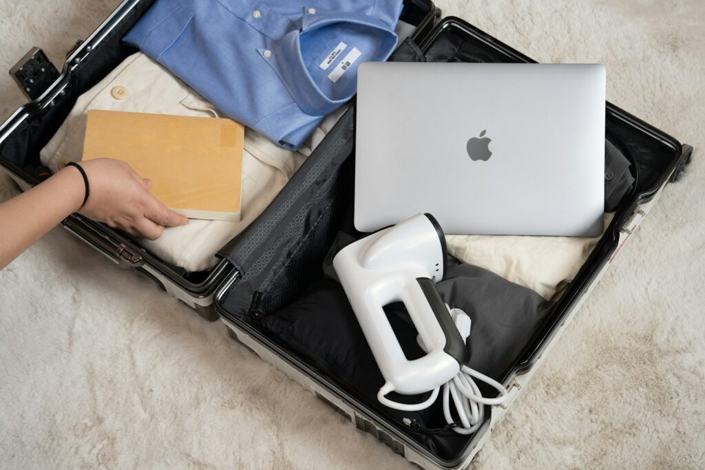 An open suitcase with a laptop and other items