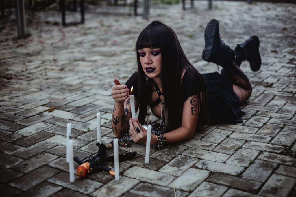 Woman lighting candles around a small doll