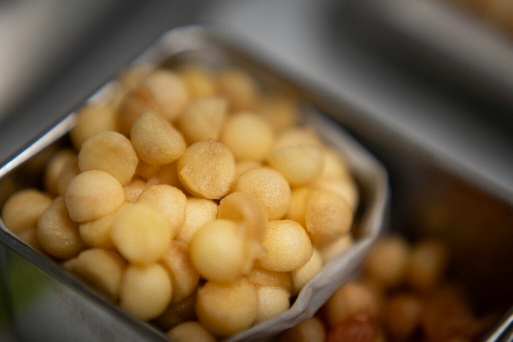A close-up of shelled macadamia nuts in a container.