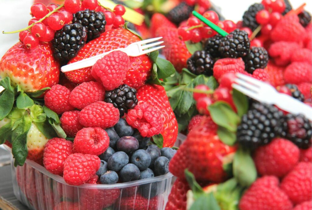 A vibrant assortment of fresh berries including strawberries, raspberries, blueberries, and blackberries.