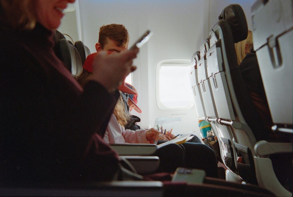 People traveling on an airplane during daytime.