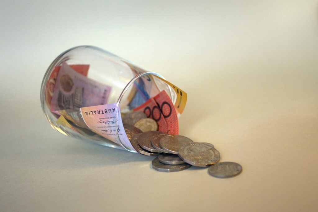 coins and coins in clear glass jar