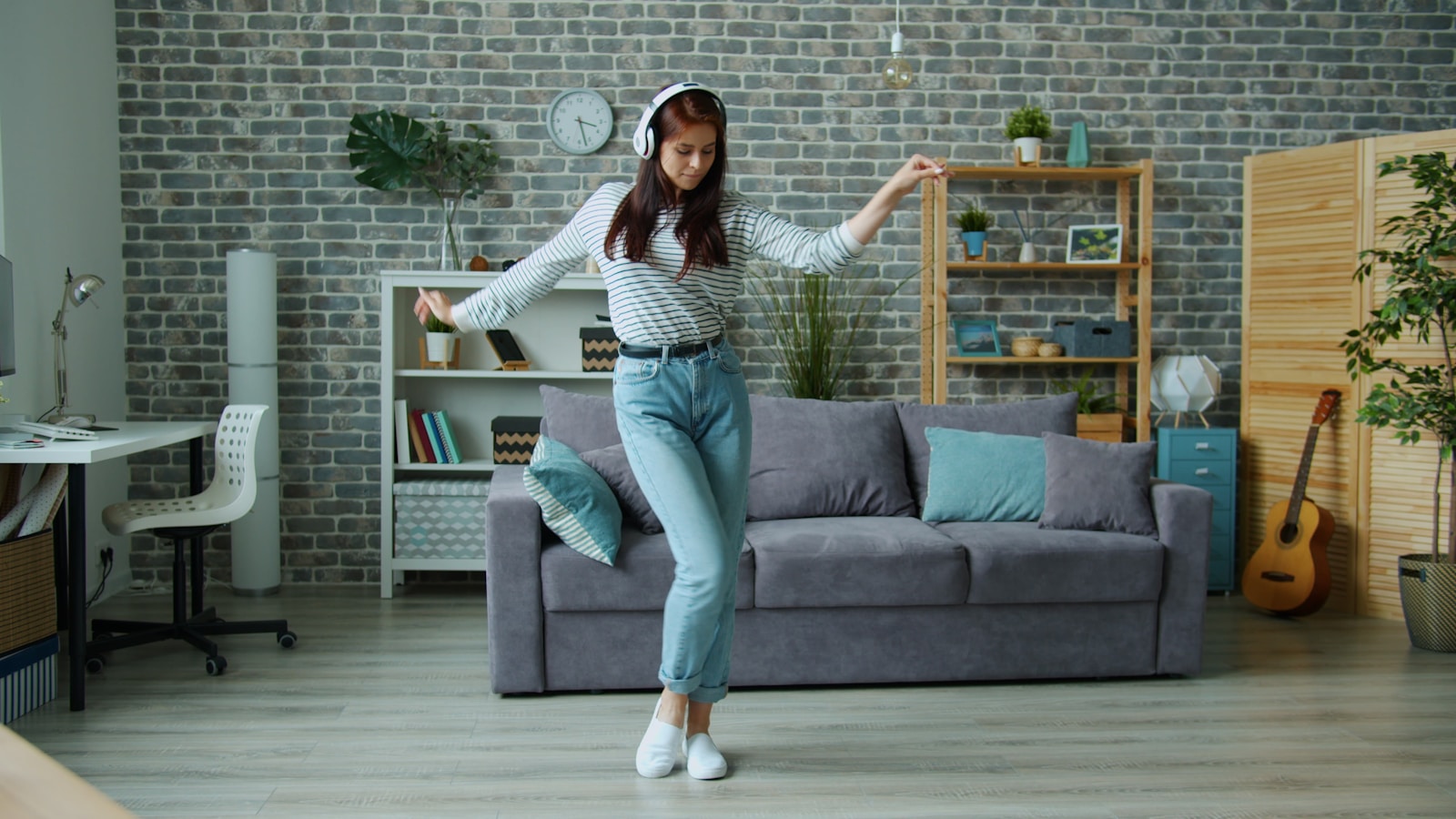 Young woman dancing while listening to music