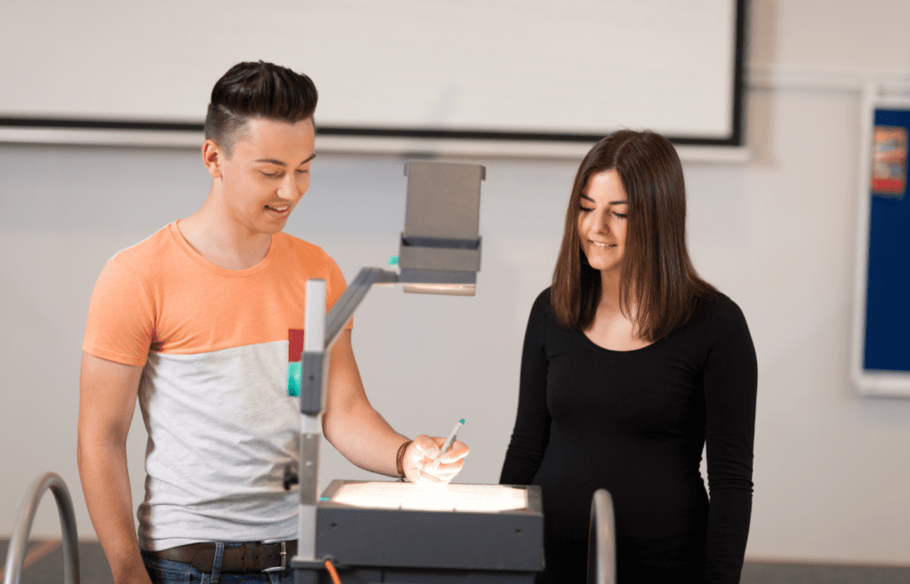 two people using a slide projector