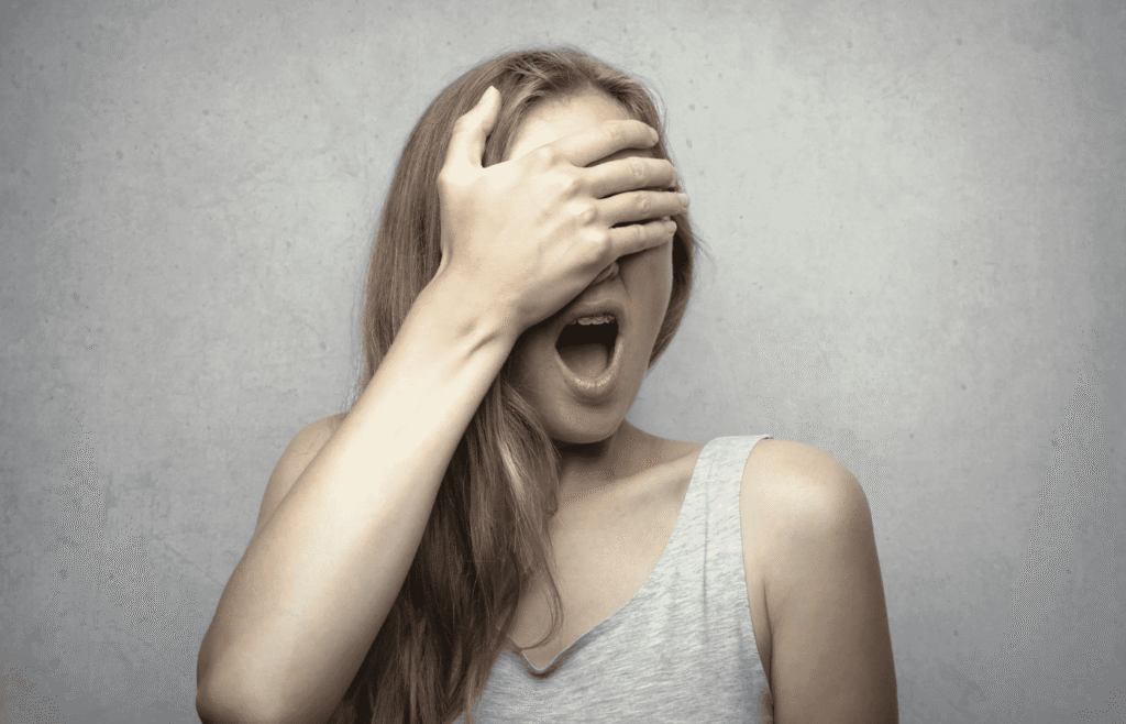 woman covering her eyes