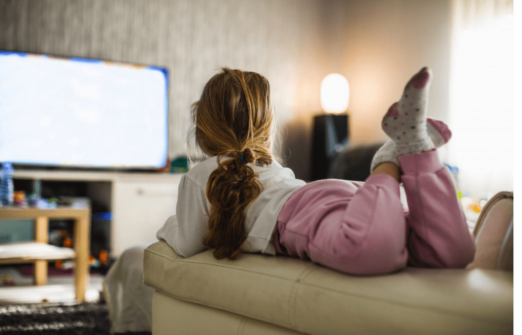little kid watching tv alone