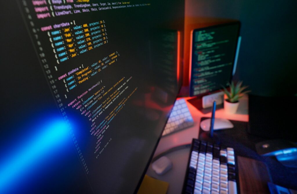 Coding code on multiple computer screens.
