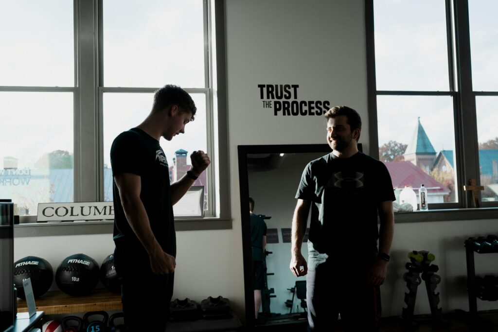 a couple of men standing in front of a window