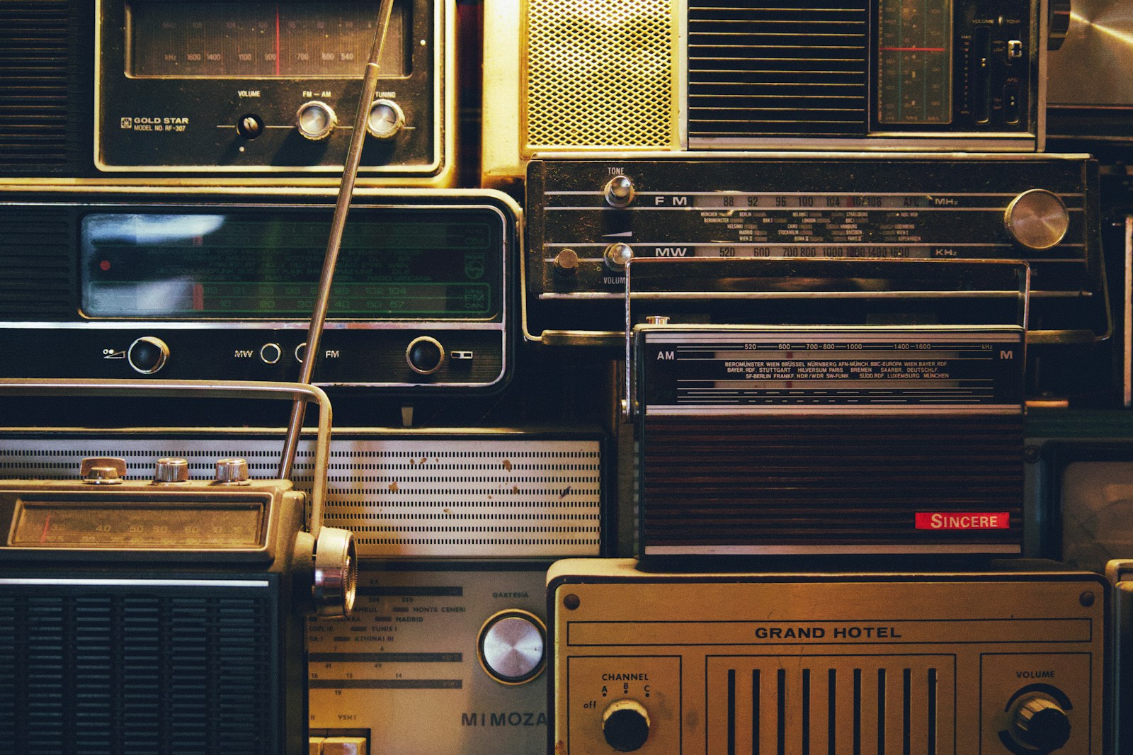 a bunch of old radio's are stacked on top of each other