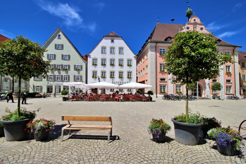 A picturesque town square in Rottenburg, Germany featuring colorful historic townhouses and a cozy outdoor cafe.