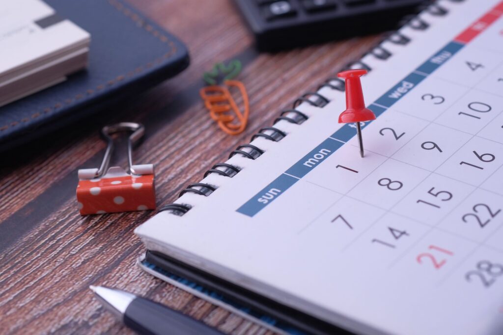 Desk elements like calendar and pins for effective planning.