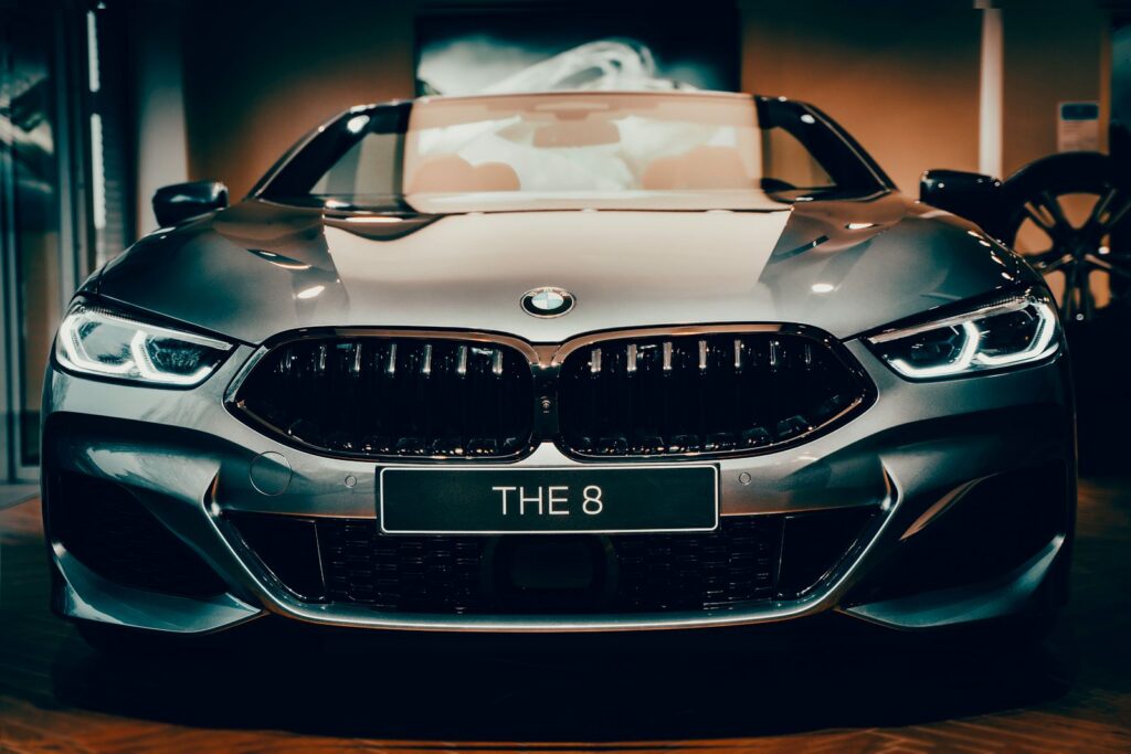 Front view of a shiny luxury BMW 8 Series car with distinctive headlights and emblem.