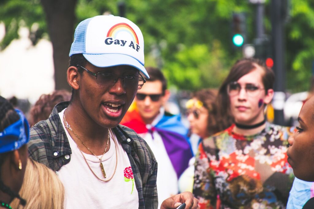 A vibrant LGBTQ+ pride event with diverse participants celebrating outdoors.