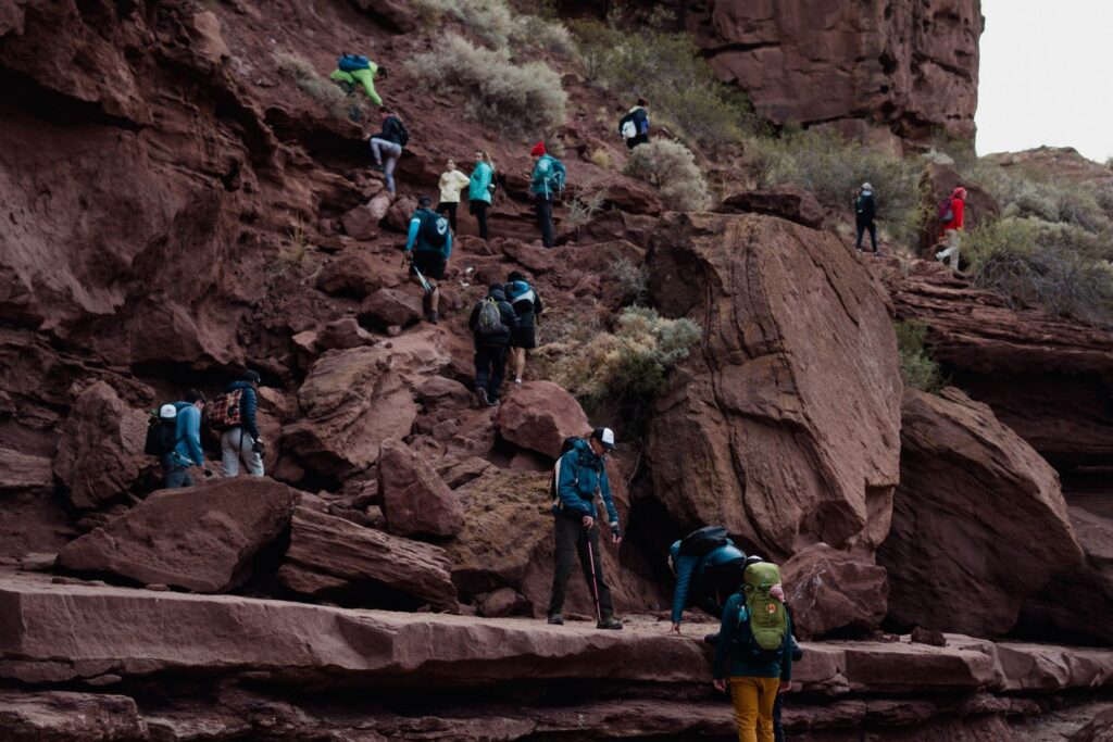 A group of hikers exploring a rugged rocky canyon outdoors, emphasizing adventure and exploration.