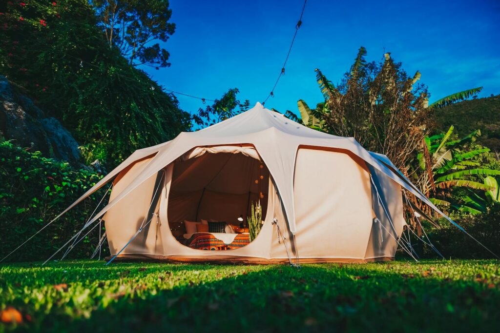 Experience luxury glamping in a beautifully set outdoor tent, perfect for a serene getaway.