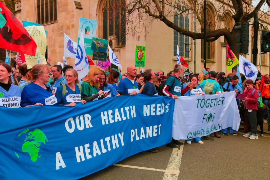 A vibrant protest in London advocating for climate change awareness and health.