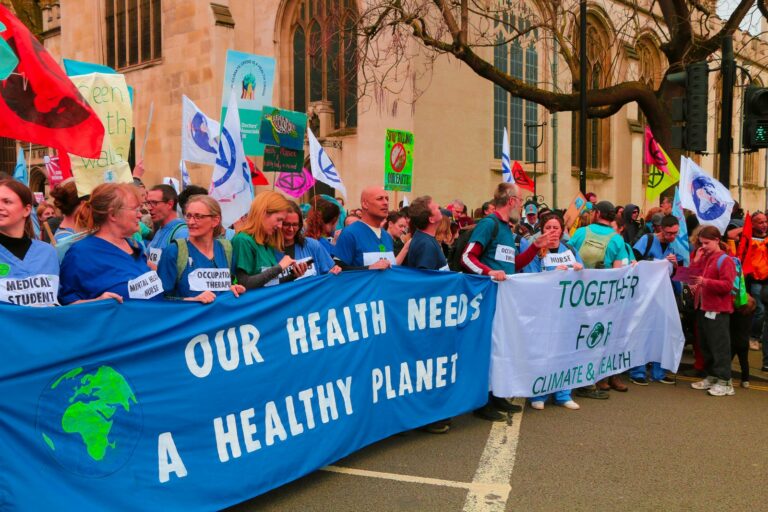 A vibrant protest in London advocating for climate change awareness and health.