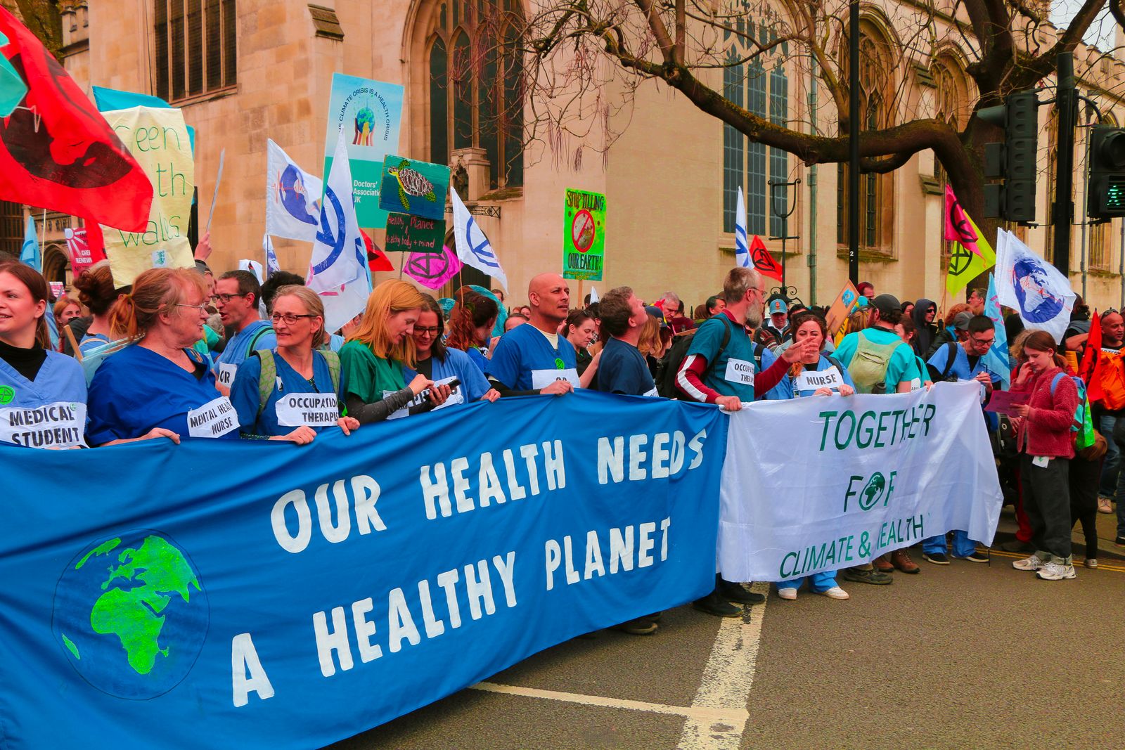 A vibrant protest in London advocating for climate change awareness and health.