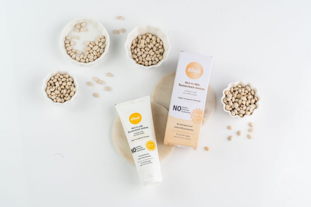 Flat lay image of sunscreen lotion with natural seeds highlighting the skincare product's organic composition.