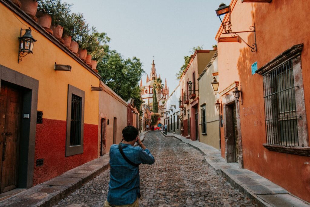 A person captures the vibrant street and architecture of San Miguel de Allende.