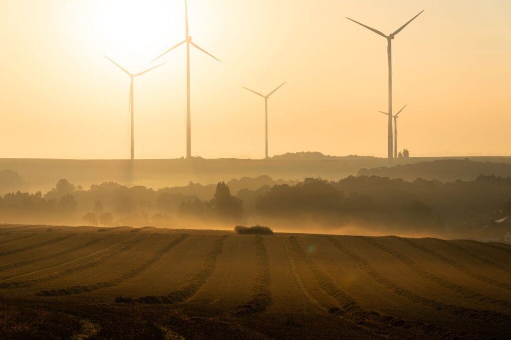 Scenic view of wind turbines in a hazy sunset over a field in Lichtenstein, Germany.
