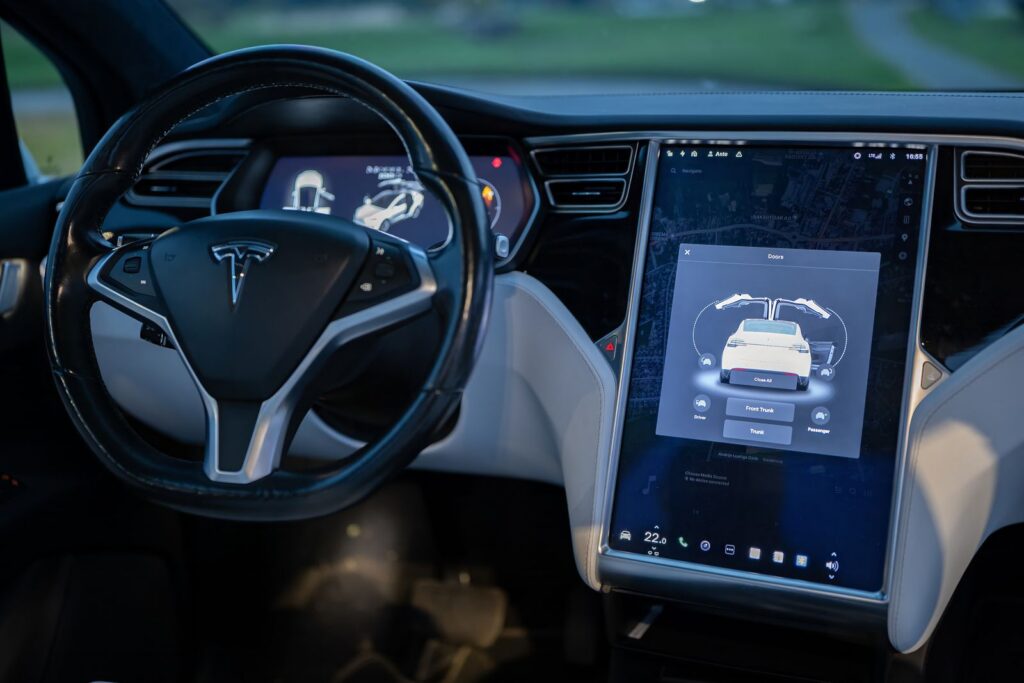 Interior shot of a modern electric car showcasing a sleek design and advanced touchscreen technology.