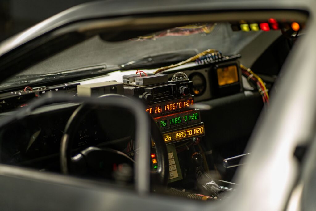 Interior of a classic car with retro futuristic gadgets and time travel elements.
