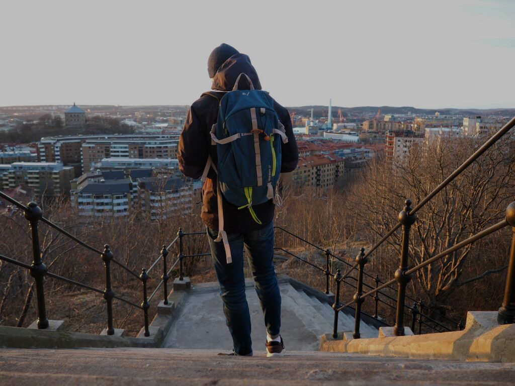 a person with a backpack walking up some stairs