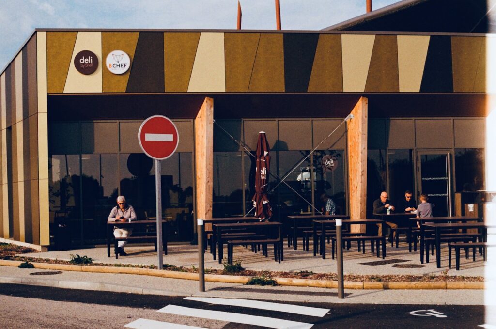 a group of people sitting at tables outside of a building