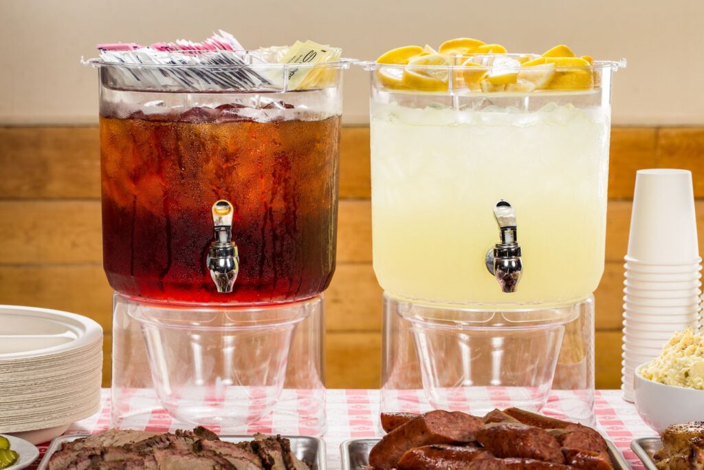 Iced tea and lemonade dispensers at a BBQ buffet in Austin, Texas.